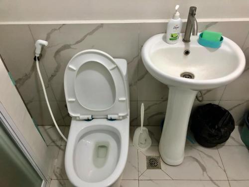 a bathroom with a toilet and a sink at Riverside 2 Bedroom 5 Beds in Naga
