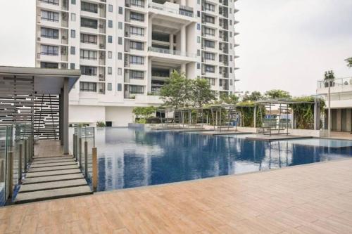 a swimming pool in front of a large building at Huge City View balcony - Netflix in Subang Jaya