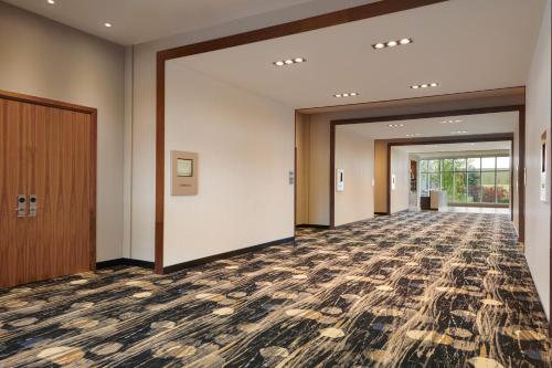 an empty hallway of a building with doors and floors at Courtyard by Marriott Calgary Airport in Calgary