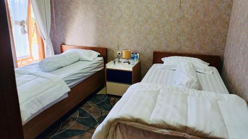 Ένα ή περισσότερα κρεβάτια σε δωμάτιο στο Homestay NGREMBOKO SOYO OMBO