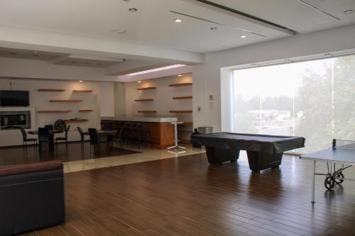 a large room with a ping pong table and a large window at Condo en Zona de Hospitales Condo en Planta Baja in Mexico City