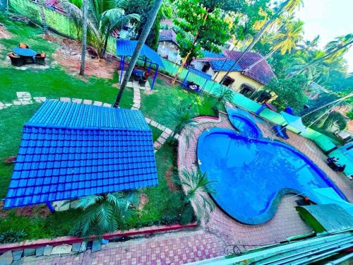an aerial view of an apple theme park with a slide at The Four Season Shivam Beach Resort, Goa in Baga
