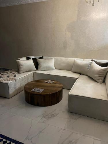 a living room with a couch and a coffee table at Riad Rkiya with Courtyard in Tiznit