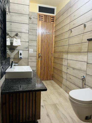 a bathroom with a sink and a toilet at DIVA Nest Kasauli I Luxury Apartment IBalcony I WiFi I Open Air Roof Top Restaurant in Kasauli