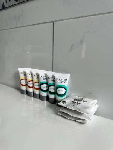a row of toothbrushes and towels on a counter at The Shamrock Hotel Balranald in Balranald