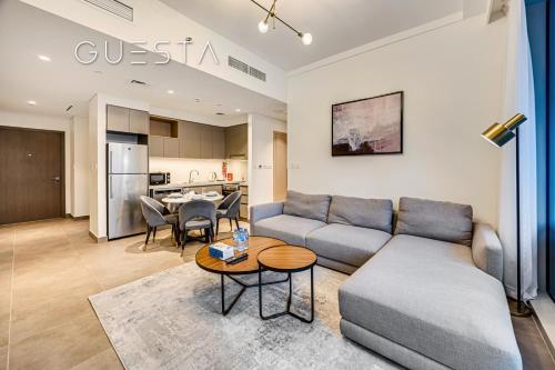 a living room with a couch and a table at Creek Gate by Emaar, Dubai Creek Harbour in Dubai