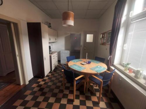a kitchen with a table and chairs in a room at Forsthaus Nicolai in Pretzsch