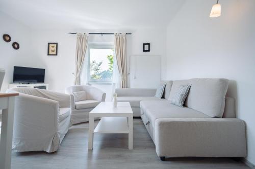 a living room with a couch and a table at Landhaus Danita in Bodensdorf
