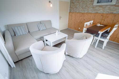a living room with a couch and chairs and a table at Landhaus Danita in Bodensdorf