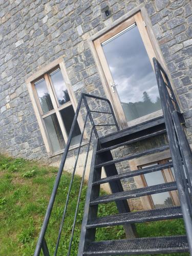 a staircase leading up to a stone building with a window at La Merveilleuse by Infiniti hôtel in Dinant
