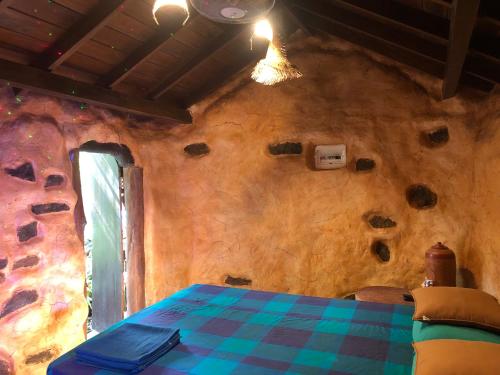 a room with a table and a wall with rocks at Villa rock by earth house in Matugama