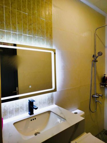 a bathroom with a sink and a mirror at Green Hope Lodge in Cat Tien