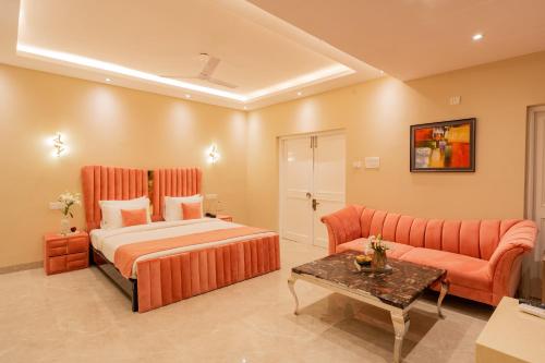 a hotel room with a bed and a couch at Emperor Ozran by Alaya Stays in Vagator
