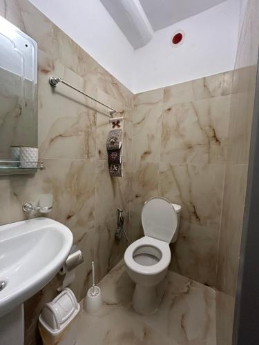a bathroom with a white toilet and a sink at Annas home in Borsh