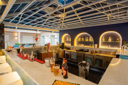a restaurant with a kitchen with arches on the wall at Emperor Ozran by Alaya Stays in Vagator