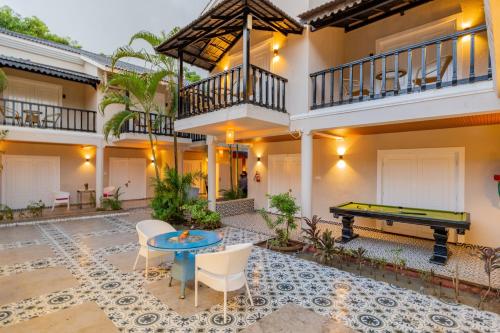 a pool table in the courtyard of a house at Emperor Ozran by Alaya Stays in Vagator