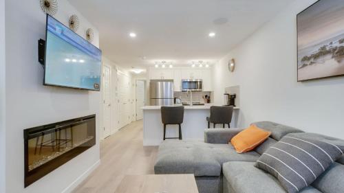 a living room with a couch and a flat screen tv at Cozy place to stay in south Calgary in Calgary