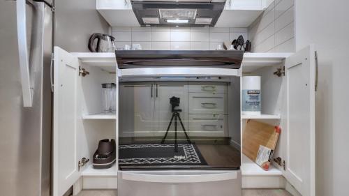 a small kitchen with a camera in the middle at Cozy place to stay in south Calgary in Calgary