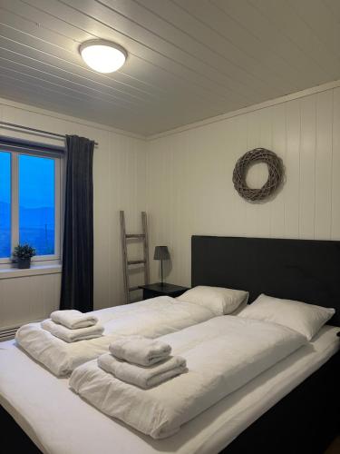 a bedroom with a large bed with towels on it at Apartment with beautiful panoramic view in Skulestadmo
