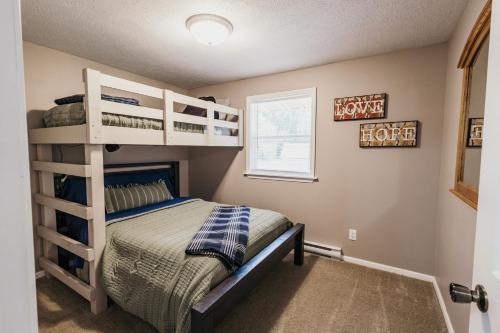 a bedroom with a bunk bed and a window at Indoor Hot-Tub! Spacious & Updated MQT Township Home! in Marquette