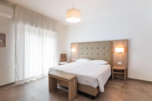a bedroom with a large bed and a large window at Rooms Angedras in Alghero