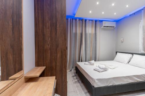 a bedroom with a bed and a blue ceiling at BSP RENT ROOMs in Paralia Sikias