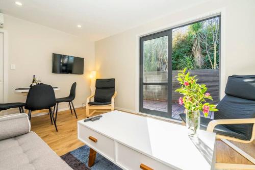 a living room with a couch and a table at Family friendly - 10min drive to Chch city centre in Christchurch