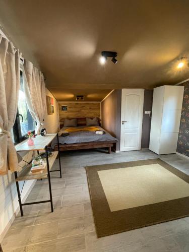 a bedroom with a bed and a table and a rug at Chalet 317 in Ucea de Sus