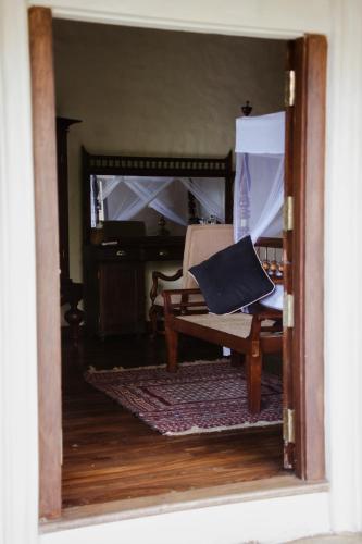 a view of a living room with a couch and a chair at Heenatigala Walawwa in Talpe