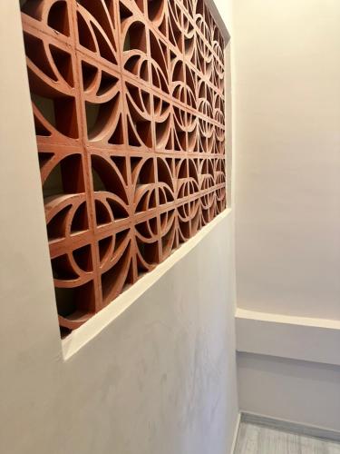 a wall mural with a laser cut wood pattern at SANTINIKETAN RETREAT, Bolpur in Shānti Niketan