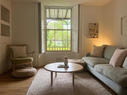 a living room with a couch and a coffee table at Cosy, convenient flat in Falmouth in Falmouth