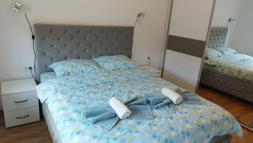 a bedroom with a bed with towels on it at Apartmani Lucky Place in Vrnjačka Banja