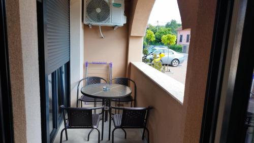 a small balcony with a table and chairs at Apartmani Lucky Place in Vrnjačka Banja