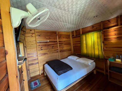 a bed in the middle of a room in a rv at Angha forest view บ้านริมไผ่ in Ban Sop Mae Klang