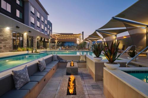 an outdoor swimming pool with a fire pit and a hotel at Fairfield Inn & Suites by Marriott Tempe in Tempe