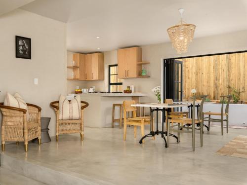 a kitchen and dining room with a table and chairs at Arc Guest House in Cape Town