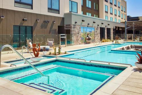a swimming pool at a hotel with a building at Fairfield Inn & Suites by Marriott Tempe in Tempe