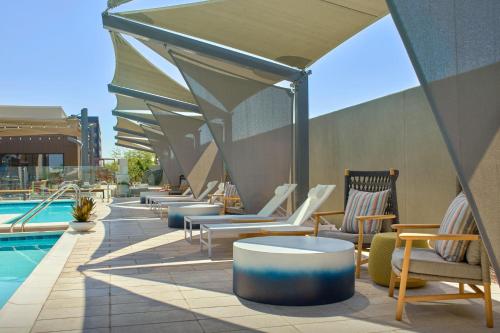 a row of chairs and tables next to a pool at Fairfield Inn & Suites by Marriott Tempe in Tempe