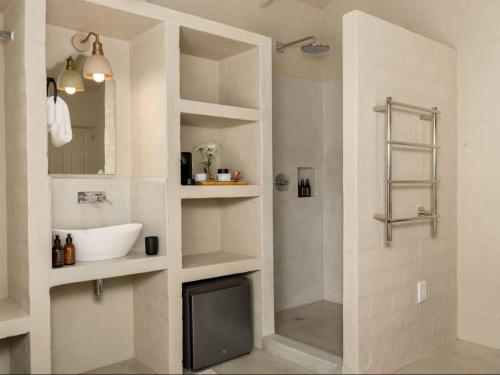 a bathroom with a sink and a shower at Arc Guest House in Cape Town