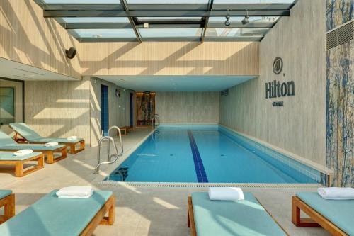 a large swimming pool in a building at Hilton Gdansk in Gdańsk