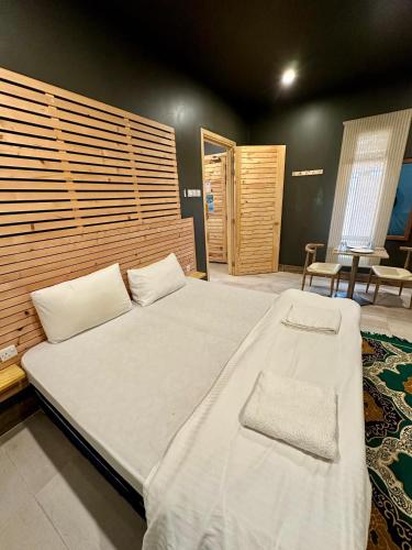 a bedroom with a large bed in a room at Beach Chalet - 6 in Al Ḩadd