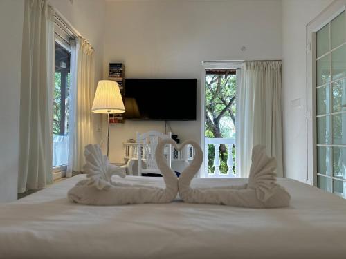 a bedroom with two swans shaped chairs on a bed at Oceanic - Luxury Boutique Hotel in Palolem