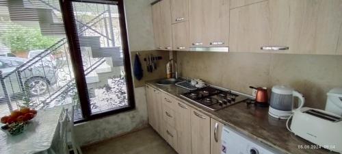 a kitchen with a sink and a stove top oven at Luka & Eka in K'obulet'i