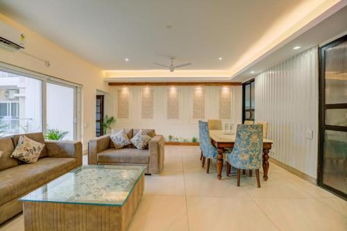 a living room with a couch and a table at Golden Healing Journeys Homestay in Rishīkesh