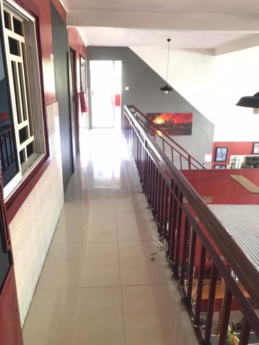 an empty hallway in a building with a staircase at Route 76 Guest House in Sen Monorom