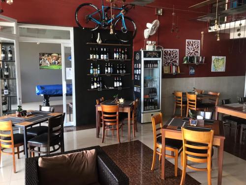 a restaurant with tables and chairs and a bar at Route 76 Guest House in Sen Monorom