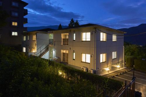 a large building with its lights on at night at Suite Villa Hakone Gora in Hakone