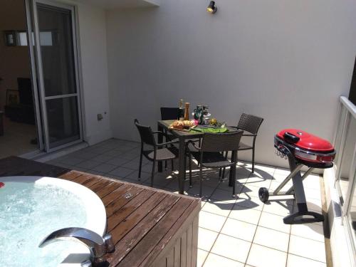 a kitchen with a table and a grill and a dining room at Alpha Terrace Onna Hills in Onna