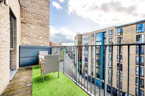 a balcony with a table and chairs and buildings at Beautiful 2 bedroom 2 bathroom apartment in Colindale in Colindale