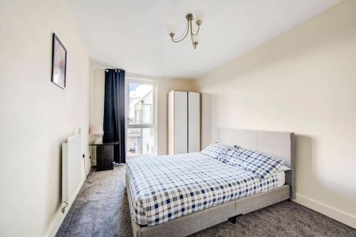 a white bedroom with a bed and a window at Beautiful 2 bedroom 2 bathroom apartment in Colindale in Colindale